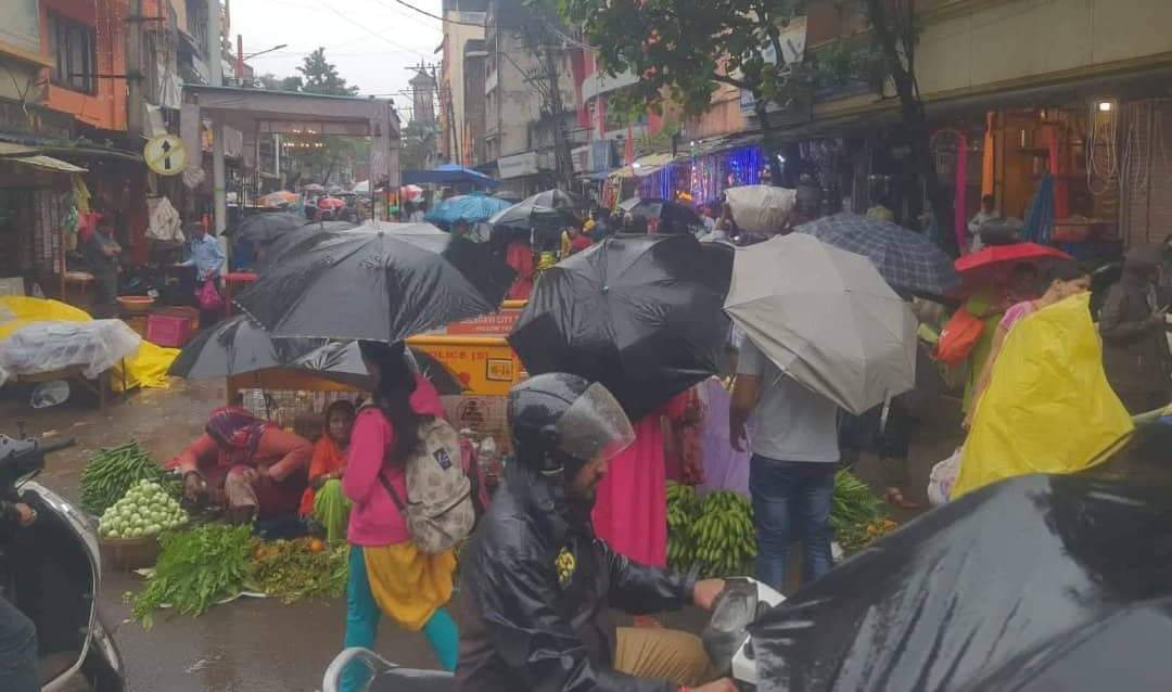 Market rush in rain